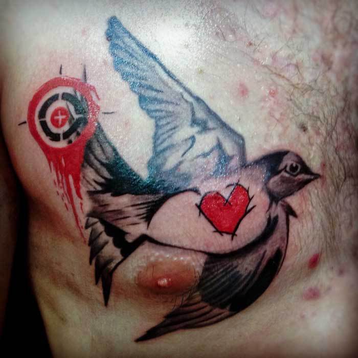 small-trash-polka-bird-chest-tattoo